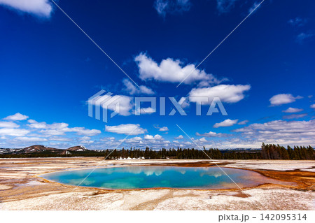 Grand Prismatic Spring at Yellowstone National Park, colorful geothermal hot spring pool under bright blue sky, Wyoming USA 142095314