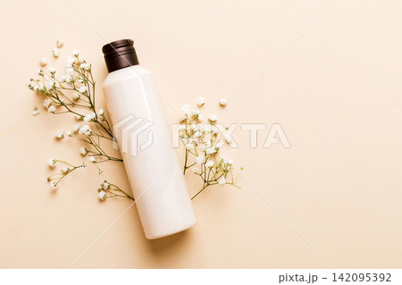 Fancy healthcare bottles for cream with gypsophila branch. Natural oranic spa cosmetics concept. Mockup, template, Top view Fancy healthcare bottles for cream with gypsophila branch. Natural oranic spa cosmetics concept. Mockup, template, Top view 142095392