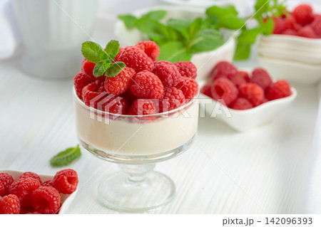 Panna cotta with fresh raspberries. 142096393