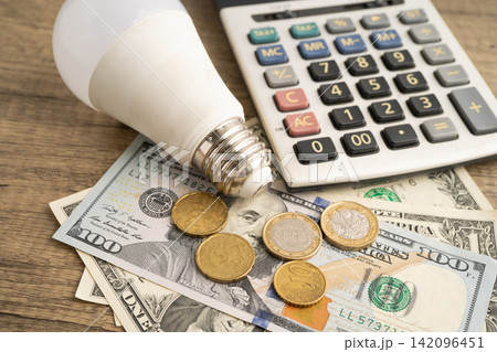 Cost of electric utilities with light bulb for payment. Cost of electric utilities with light bulb for payment. 142096451