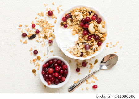 Healthy breakfast food with granola, yogurt, fruits and nuts. Dessert parfait with dried fruits for breakfast 142096696