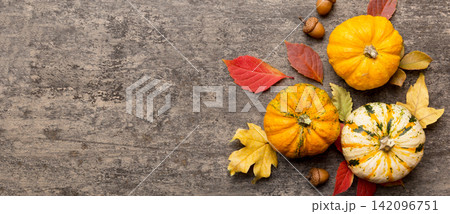 Autumn composition. Pattern made of dried leaves and other design accessories on table. Flat lay, top view 142096751