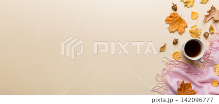 Flat lay composition with colorful Autumn cup of coffee and leaves on a color background. top view 142096777