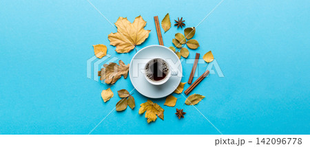 Flat lay composition with colorful Autumn cup of coffee and leaves on a color background. top view 142096778