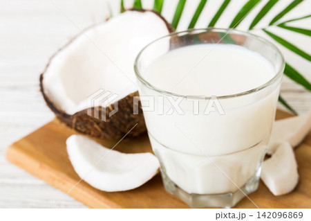 coconut products on white wooden table background. Dairy free milk substitute drink, Flat lay healthy eating coconut products on white wooden table background. Dairy free milk substitute drink, Flat lay healthy eating 142096869