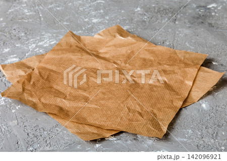 top view with baking parchment empty on table background. Folded cloth for mockup with copy space, Flat lay. Minimal style top view with baking parchment empty on table background. Folded cloth for mockup with copy space, Flat lay. Minimal style 142096921