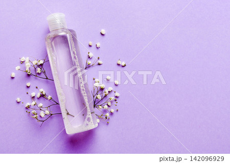 Fancy healthcare bottles for serum, micellar, tonic, toner, lotion, water and cream with gypsophila branch. Natural oranic spa cosmetics concept. Mockup, template, Top view Fancy healthcare bottles for serum, micellar, tonic, toner, lotion, water and cream with gypsophila branch. Natural oranic spa cosmetics concept. Mockup, template, Top view 142096929