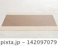 Perspective view of brown tablecloth for food on cement background. Empty space for your design 142097079
