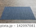 Perspective view of blue tablecloth for food on cement background. Empty space for your design 142097081