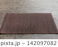 Perspective view of brown tablecloth for food on cement background. Empty space for your design 142097082