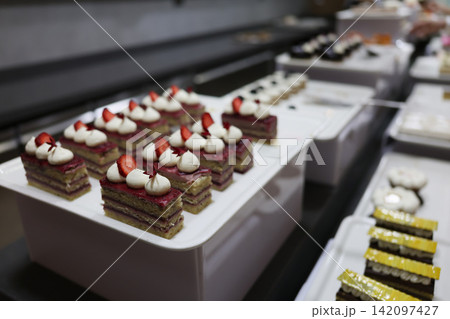 Delightful sweets waiting to charm taste buds in a bustling bakery kitchen Delightful sweets waiting to charm taste buds in a bustling bakery kitchen 142097427