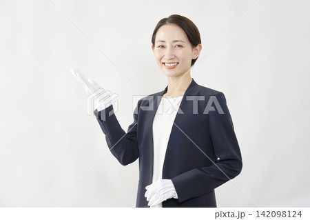手のひらで左側を指す女性鑑定士 白背景 手のひらで左側を指す女性鑑定士 白背景 142098124