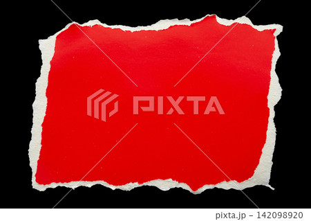 piece of red cardboard paper tear isolated on black background piece of red cardboard paper tear isolated on black background 142098920