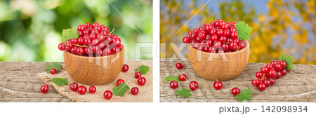 Red currant berries in wooden bowl on wooden table with blurry garden background Red currant berries in wooden bowl on wooden table with blurry garden background 142098934