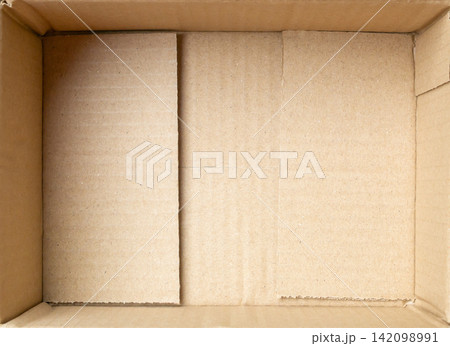 Open empty brown cardboard box background top view 142098991
