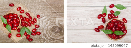 dogwood berry with leaf in bowl on old wooden background with copy space for your text. Top view dogwood berry with leaf in bowl on old wooden background with copy space for your text. Top view 142099047