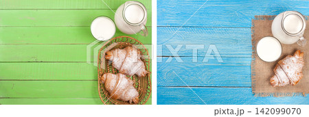 jug and glass of milk with croissants on a green and blue wooden background with copy space for your text. Top view jug and glass of milk with croissants on a green and blue wooden background with copy space for your text. Top view 142099070