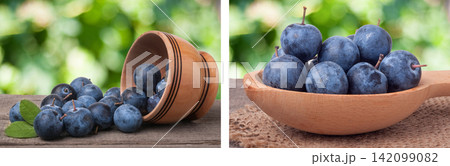blackthorn berries in a wooden bowl on table with sacking and blurred background blackthorn berries in a wooden bowl on table with sacking and blurred background 142099082