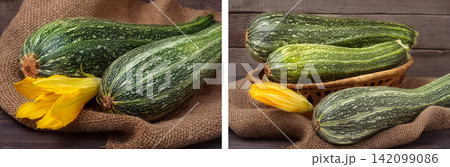 two zucchini on sackcloth and wooden background with flower two zucchini on sackcloth and wooden background with flower 142099086