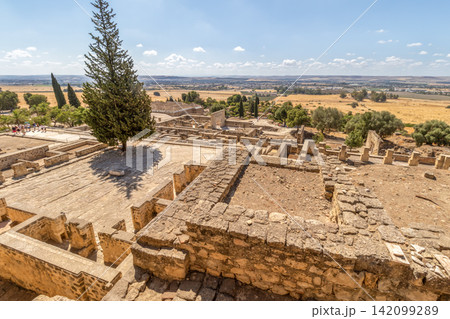 Historical landscape of Medina Azahara ruins near Cordoba, Spain. Panoramic archaeological site view perfect for educational, tourism, travel advertising, and heritage stock media collections. Historical landscape of Medina Azahara ruins near Cordoba, Spain. Panoramic archaeological site view perfect for educational, tourism, travel advertising, and heritage stock media collections. 142099289