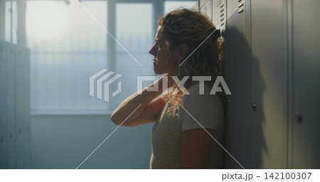 Female Educator Finds Calm Pause in Empty School Changing Area, Creating Space Mentally Reset Female Educator Finds Calm Pause in Empty School Changing Area, Creating Space Mentally Reset 142100307