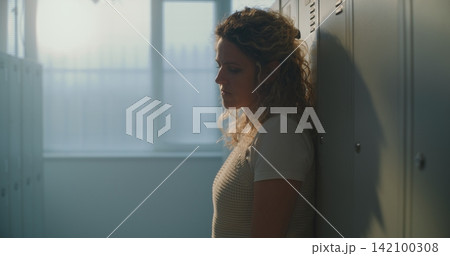 Female Educator Finds Calm Pause in Empty School Changing Area, Creating Space Mentally Reset Female Educator Finds Calm Pause in Empty School Changing Area, Creating Space Mentally Reset 142100308
