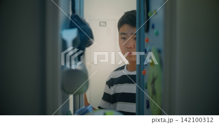 Teenage Student Opens Door, Reaches for Smartphone and Chats Teenage Student Opens Door, Reaches for Smartphone and Chats 142100312