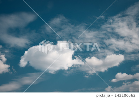 White clouds drifting across a deep blue sky, creating a serene wallpaper 142100362