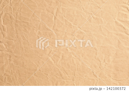 Macro closeup of ccrumpled kraft brown paper texture Macro closeup of ccrumpled kraft brown paper texture 142100372