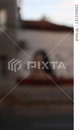 Portrait of a woman against a white wall. 142100662