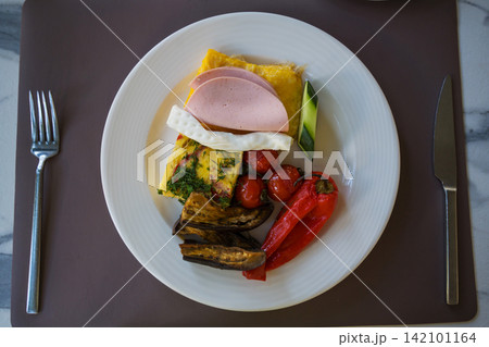 Healthy hotel breakfast with omelette, vegetables and ham, travel holiday leisure food concept Healthy hotel breakfast with omelette, vegetables and ham, travel holiday leisure food concept 142101164