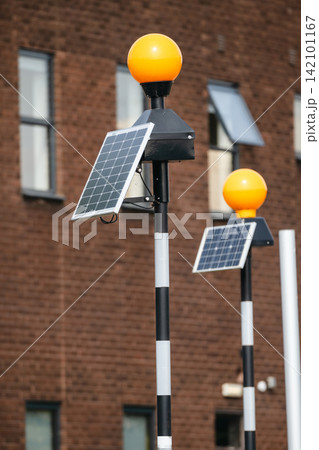 Solar-powered warning lights with photovoltaic panels outside the airport Solar-powered warning lights with photovoltaic panels outside the airport 142101167