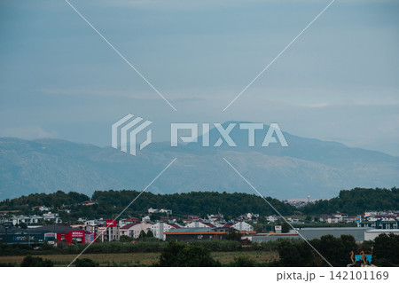 Side, Turkey, July 20, 2026: View of the Taurus Mountains overlooking the urban landscape and countryside Side, Turkey, July 20, 2026: View of the Taurus Mountains overlooking the urban landscape and countryside 142101169