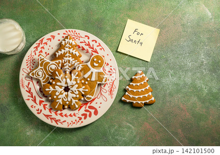 Holiday background. Christmas gingerbread cookies for Santa, festive food, home baking. Flat lay 142101500