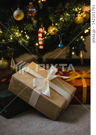 Holiday background, gift boxes next to Christmas tree. Abstract Christmas background, lifestyle Holiday background, gift boxes next to Christmas tree. Abstract Christmas background, lifestyle 142101761