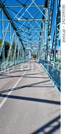 Geometric shadows on a historic steel truss bridge in Brezice Slovenia 142104590