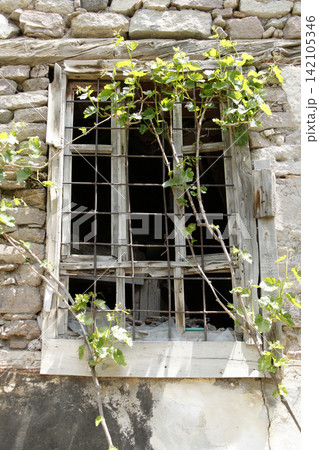 broken window of an old stone house 142105346