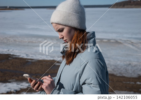Young woman calling for help on frozen lake Young woman calling for help on frozen lake 142106055