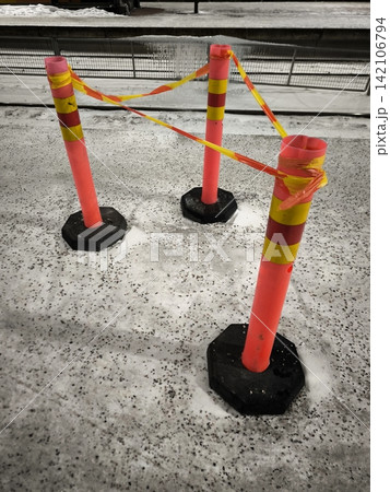 Warning barriers on ice and snow. Traffic restrictions or danger zones in winter Warning barriers on ice and snow. Traffic restrictions or danger zones in winter 142106794