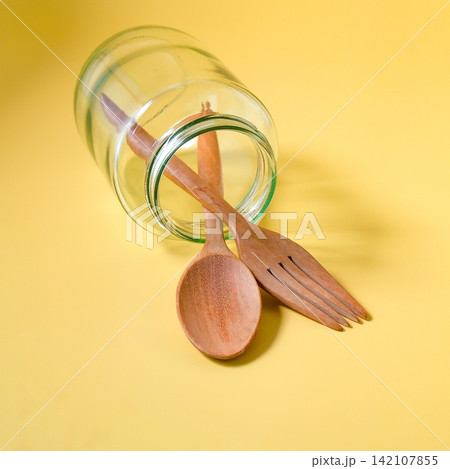 Wood spoon and fork in glass jar. Wood spoon and fork in glass jar. 142107855