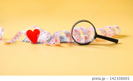 A measuring tape with magnifying glass ,Business concept. A measuring tape with magnifying glass ,Business concept. 142108001