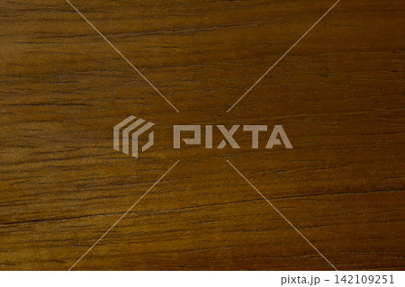 Brown wood surface showing intricate grain patterns and natural texture, offering a rustic and warm background for various design applications Brown wood surface showing intricate grain patterns and natural texture, offering a rustic and warm background for various design applications 142109251