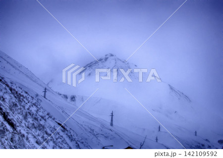 Winter snow covered mountain region of peak Kazbegi in Caucasus mountains. 142109592