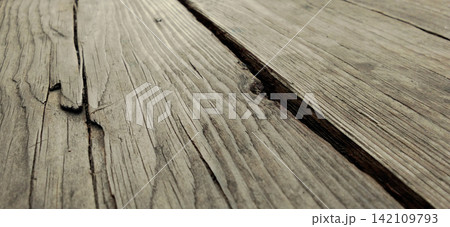 Rustic style wood planks that appear weathered, with deep grain and cracks. Rustic style wood planks that appear weathered, with deep grain and cracks. 142109793