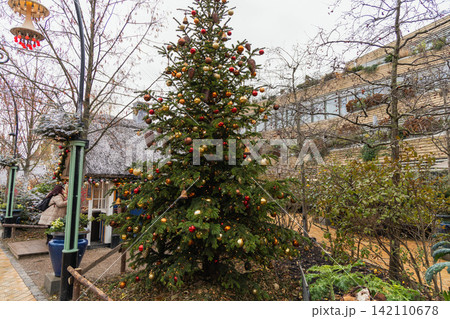 Festive Christmas tree decorated with colorful ornaments Festive Christmas tree decorated with colorful ornaments 142110678