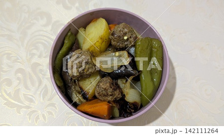Meatballs and roasted vegetables in a pink bowl Meatballs and roasted vegetables in a pink bowl 142111264