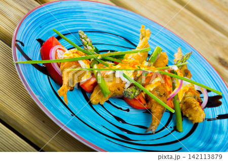 Fried in batter sprats with creamy ginger sauce, tomatoes, balsamic paste Fried in batter sprats with creamy ginger sauce, tomatoes, balsamic paste 142113879