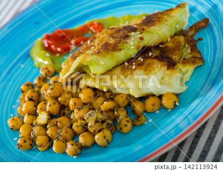 Close up of leaves of cabbage in batter and cheakpea with sauce 142113924