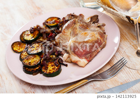 Picture of delicious fried pork with lentils at plate 142113925