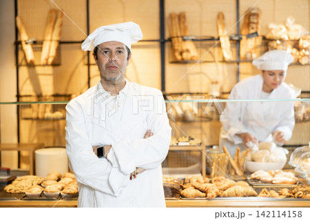 Confident male baker welcoming everyone into his bakery 142114158